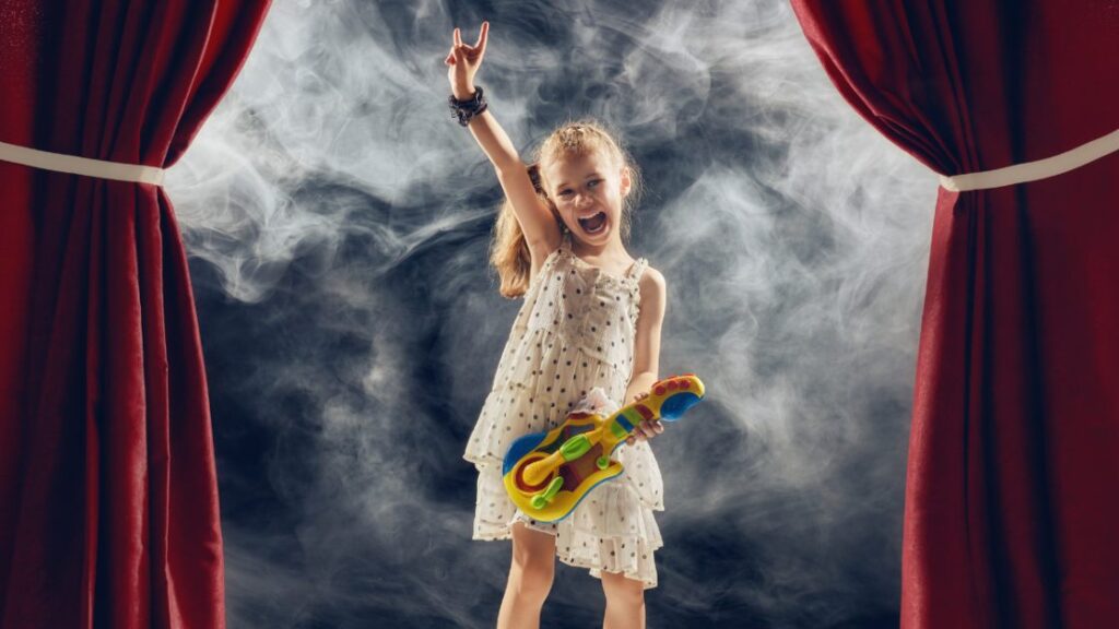 kid playing music on stage