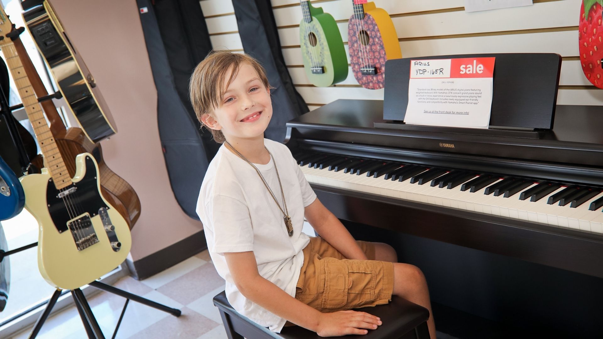 student sitting at piano