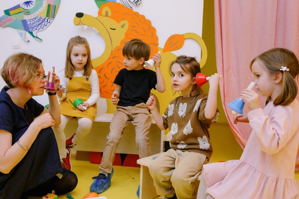Teacher with Her Students Holding Different Color Bells